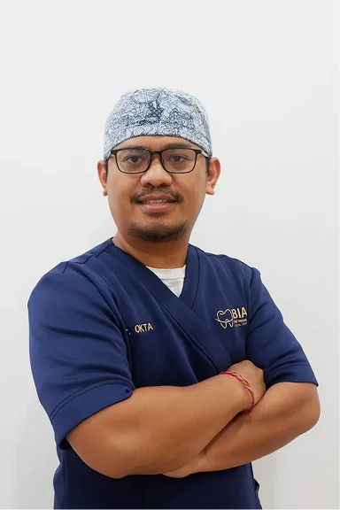 dr. Okta, M.Biomed, Sp.An-Ti., CIPS.